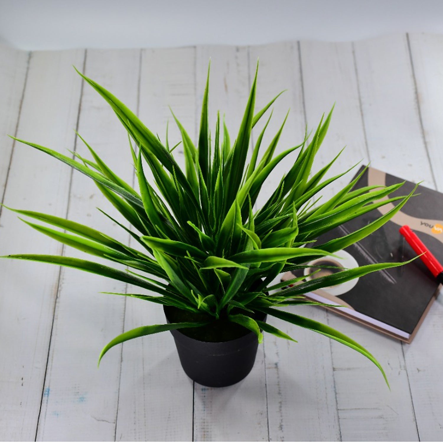 Artificial potted plant with a decorative pot.