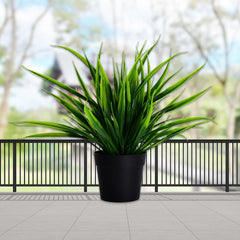 Artificial plant in a decorative pot.